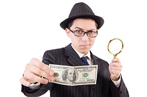 Detective with money - Do you need a close examination of some assets?  [Image © Elnur - fotolia.com]